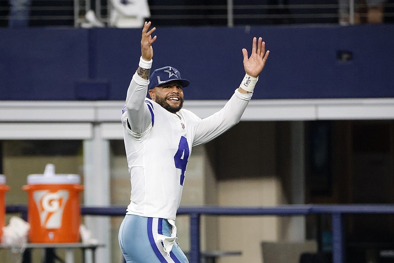 Dallas Cowboys running back Ezekiel Elliott smiles on the sideline