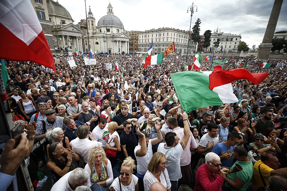People gather in Piazza del Popolo square during a protest, in Rome, Saturday, Oct. 9, 2021. Thousands of demonstrators protested Saturday in Rome against the COVID-19 health pass that Italian workers, both the public and private sectors, must display to access their workplaces from Oct. 15 under a government decree. (Cecilia Fabiano/LaPresse via AP)