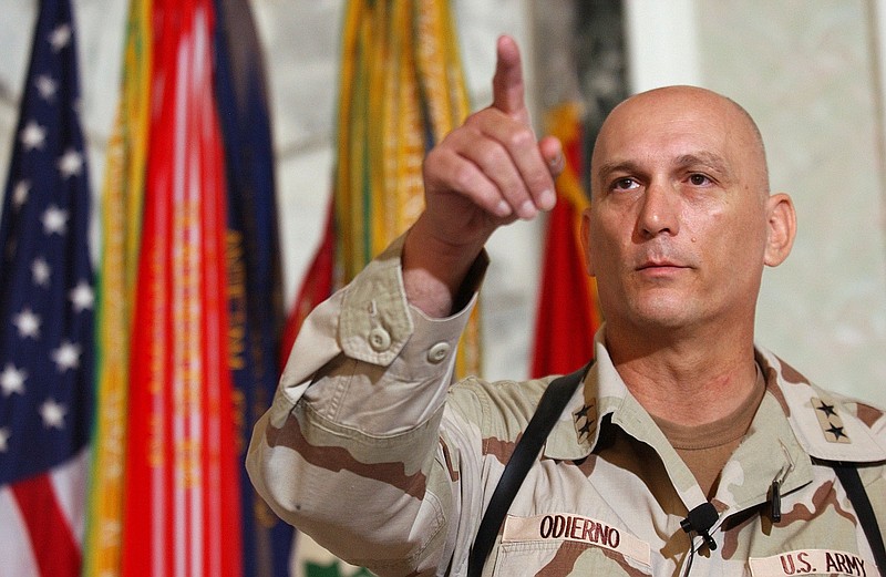 FILE - In this Aug. 7, 2003 file photo, Major General Raymond Odierno, commander of the U.S. Army Fourth Infantry Division gestures during a news conference in Tikrit, about 180 kms. (112 miles) northwest of Baghdad, Iraq.  Odierno, a retired Army general who commanded American and coalition forces in Iraq at the height of the war and capped a 39-year career by serving as the Army's chief of staff, has died, his family said Saturday, Oct. 9, 2021. He was 67.  (AP Photo/Dario Lopez-Mills, File)