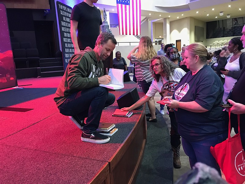 Staff photo by Greg Bischof
Kirk Cameron signs books following his spiritual message delivered Sunday evening at First Baptist Church, Texarkana. Cameron became an Evangelical Christian before he was 20 years old.