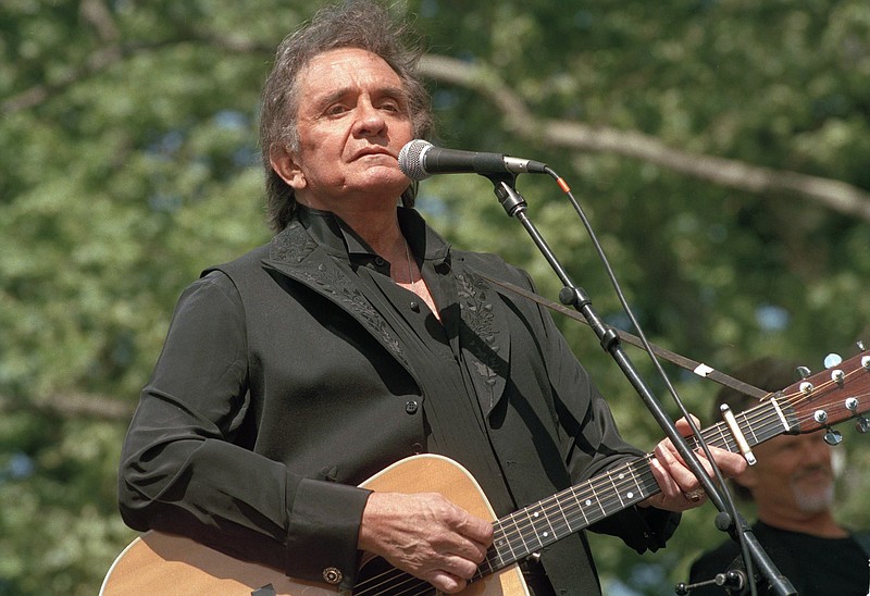 Country legend Johnny Cash, circa 1993, performs at a benefit concert at Central Park in New York. Arkansas celebrates its native son each year with the Johnny Cash Heritage Festival. (AP file photo/Joe Tabacca)