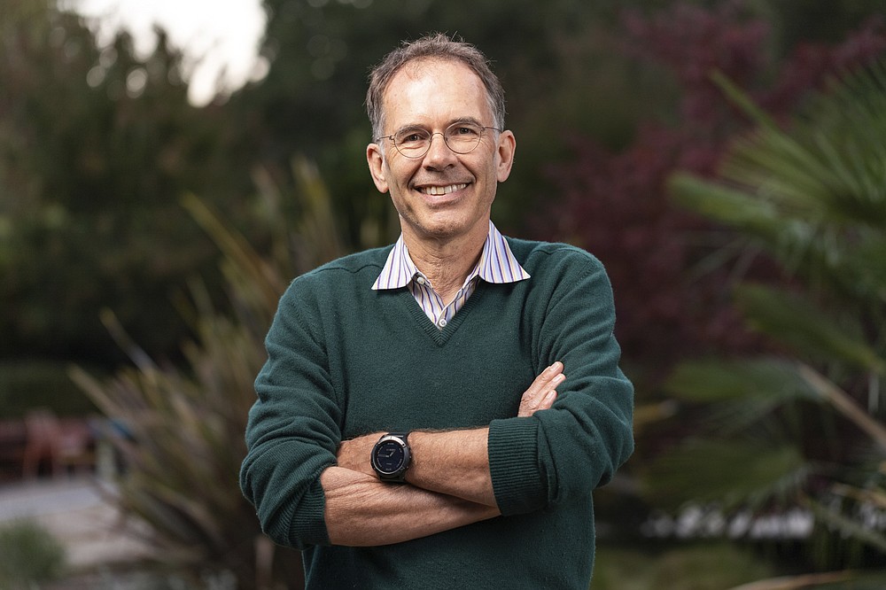 In this photo provided by Stanford University, Guido Imbens poses for a portrait at his home in Stanford, Calif, Monday, Oct. 11, 2021, after learning he shared in winning the Nobel prize in economics. The U.S.-based economist won for pioneering research that transformed widely held ideas about the labor force. Two others shared the award for developing ways to study these types of societal issues. (Andrew Brodhead/Stanford University via AP)