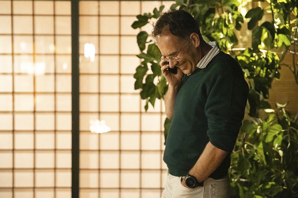 In this photo provided by Stanford University, Guido Imbens takes a congratulatory call at his home in Stanford, Calif, Monday, Oct. 11, 2021, after learning he shared in winning the Nobel prize in economics. The U.S.-based economist won for pioneering research that transformed widely held ideas about the labor force. Two others shared the award for developing ways to study these types of societal issues. (Andrew Brodhead/Stanford University via AP)