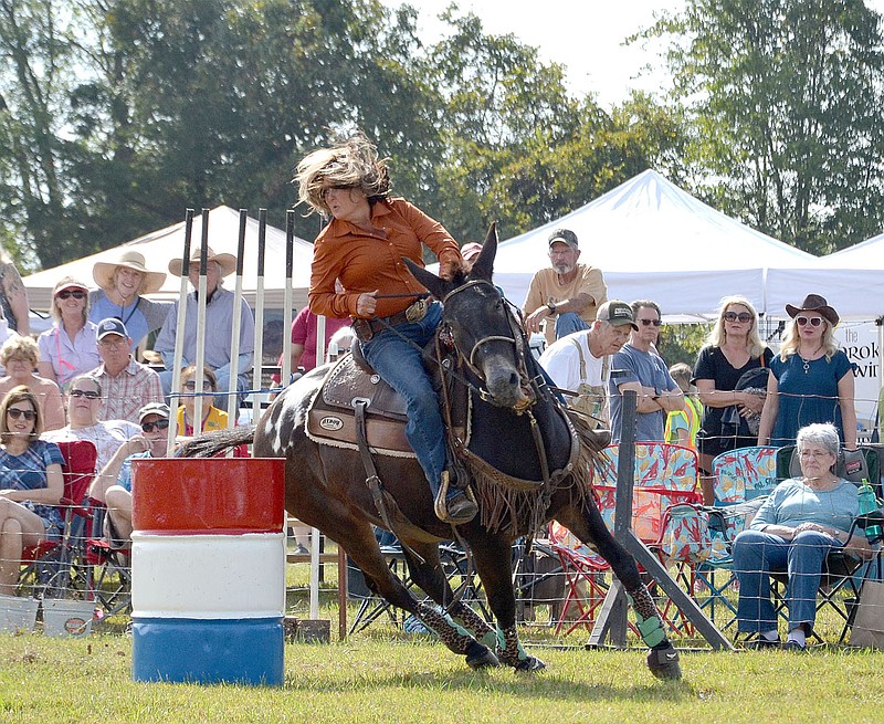 Becki Sams rounds a barrel during the barrel race.