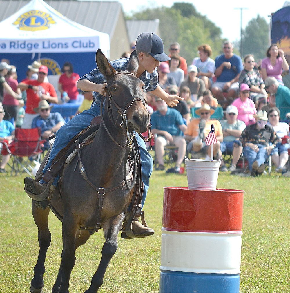 A youth carefully places the flag in the bucket as the last portion of the flag race Saturday.
