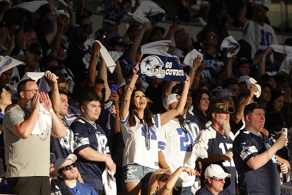 Fans cheer late in the second half of an NFL football game between the New York Giants and Dallas Cowboys in Arlington, Texas, Sunday, Oct. 10, 2021. (AP Photo/Michael Ainsworth)