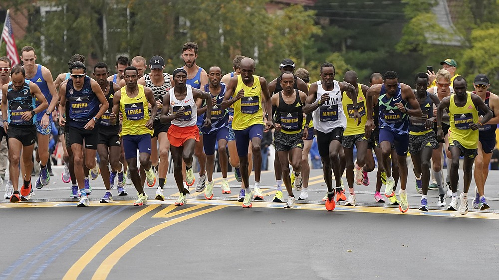 The elite men break from the starting line of the 125th Boston Marathon, Monday, Oct. 11, 2021, in Hopkinton, Mass. (AP Photo/Steven Senne)
