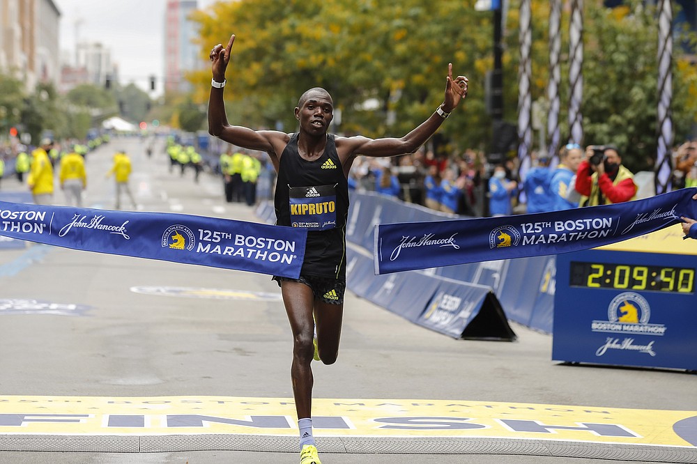 Benson Kipruto, of Kenya, approaches the tape to win the 125th Boston Marathon on Monday, Oct. 11, 2021, in Boston. (AP Photo/Winslow Townson)