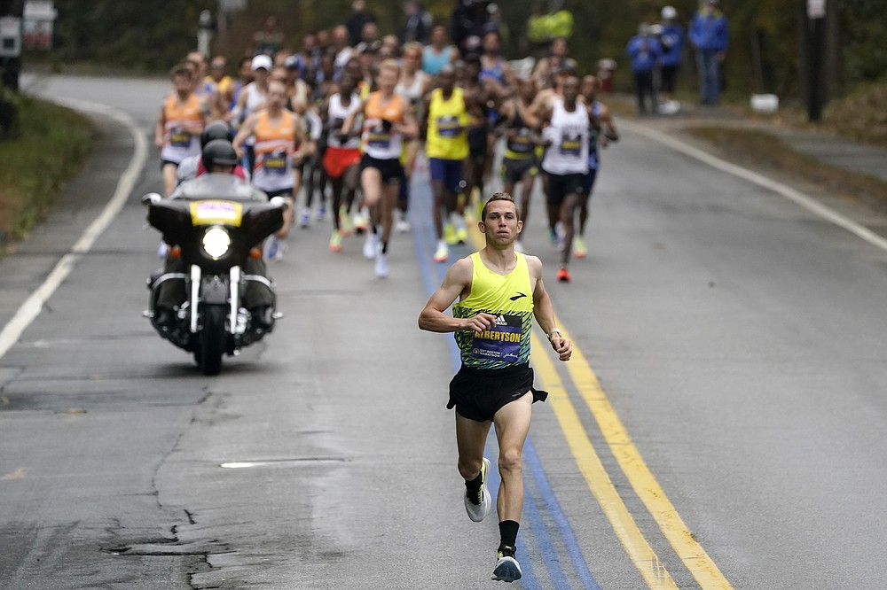CJ Albertson, of Fresno, Calif., front, leads a group of elite men in the 125th Boston Marathon, Monday, Oct. 11, 2021, in Hopkinton, Mass. (AP Photo/Steven Senne)