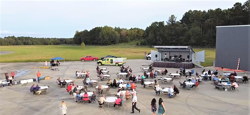 In this aerial photo, a crowd watches as local band Blackstrap performs at Business After Hours. The event was hosted Sept. 28 at South Arkansas Regional Airport at Goodwin Field. Airport manager Johnathan Estes said such events help to promote the airport and its commercial air carrier Southern Airways Express, who hosted this month's Business After Hours event, along with SARA and the El Dorado-Union County Chamber of Commerce, in September. (Contributed)