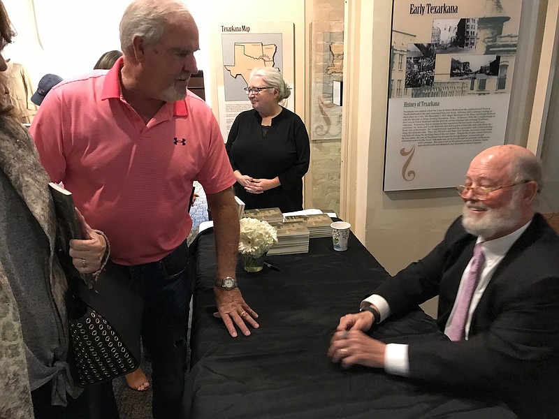 Staff photo by Greg Bischof
Texarkana native Robert Couch signs copies of a new book he wrote titled “Uncle Brice, A Killing, A Trial, A True Story. The bok focuses on a family secret and a true crime.