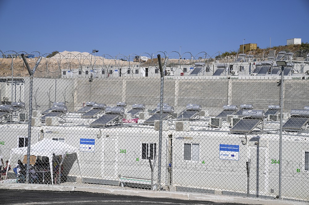 A partial view of the new closed monitored facility for migrants and refugees in Zervou village, on the eastern Aegean island of Samos, Greece, Friday, Oct. 1, 2021. Greek authorities have moved ten days ago asylum-seekers living in a squalid camp on the island of Samos into a new facility on the island, where access are more strictly controlled. (AP Photo/Thanassis Stavrakis)