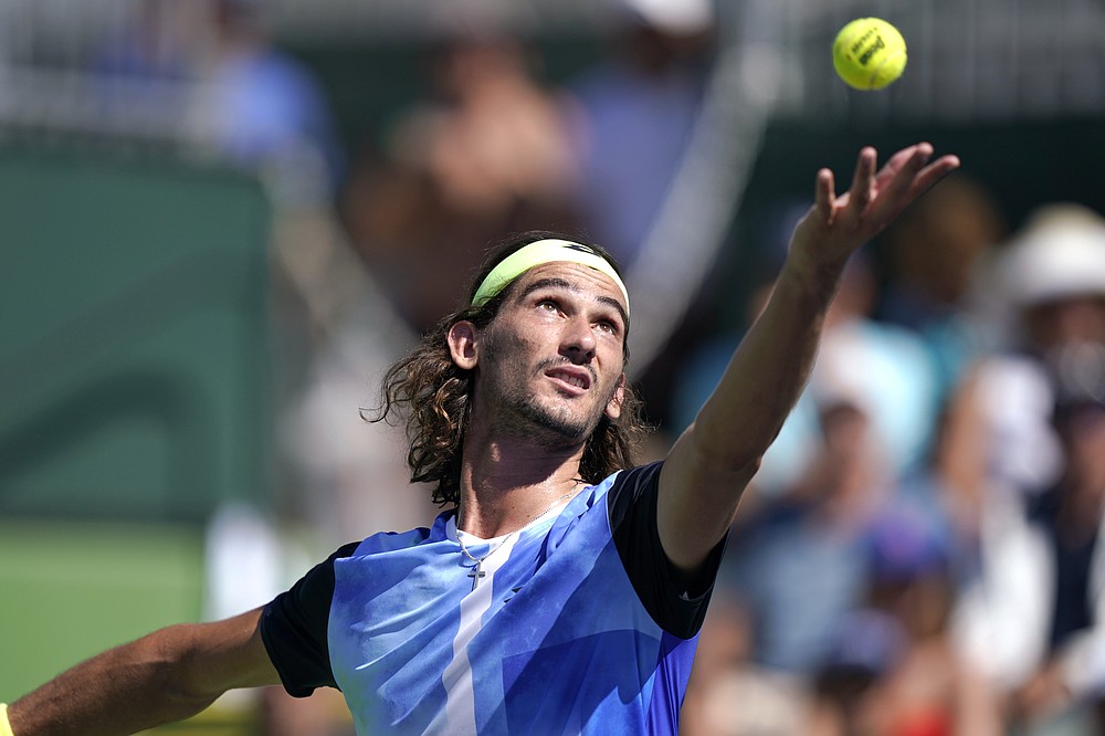 Lloyd Harris, of South Africa, serves to Casper Ruud, of Norway, at the BNP Paribas Open tennis tournament Monday, Oct. 11, 2021, in Indian Wells, Calif. (AP Photo/Mark J. Terrill)