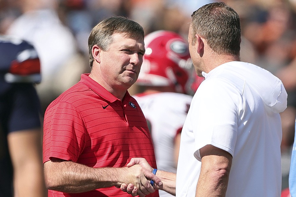Georgia head coach Kirby Smart and Auburn head coach Bryan Harsin shake hands before the first half of an NCAA college football game Saturday, Oct. 9, 2021, in Auburn, Ala. (AP Photo/Butch Dill)