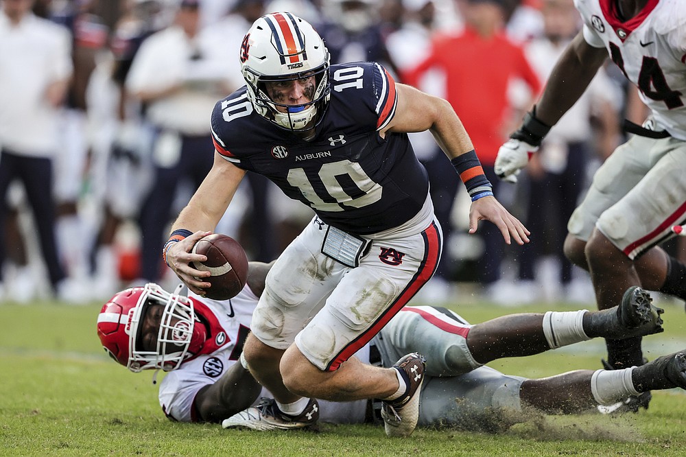 Auburn quarterback Bo Nix (10) is sacked by Georgia linebacker Quay Walker (7) during the second half of an NCAA college football game Saturday, Oct. 9, 2021, in Auburn, Ala. (AP Photo/Butch Dill)
