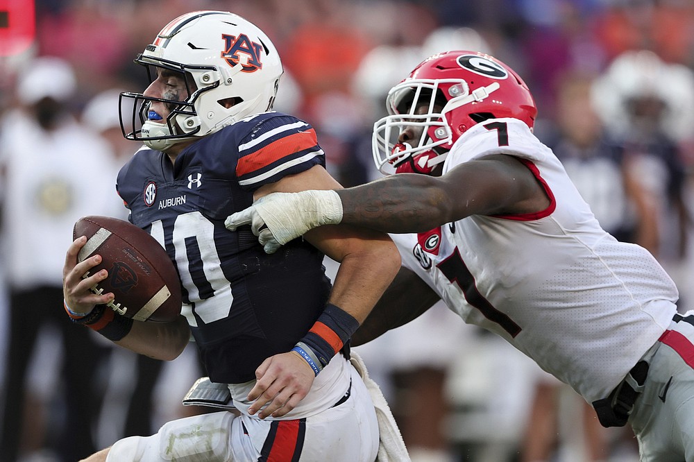 Auburn quarterback Bo Nix (10) is sacked by Georgia linebacker Quay Walker (7) during the second half of an NCAA college football game Saturday, Oct. 9, 2021, in Auburn, Ala. (AP Photo/Butch Dill)