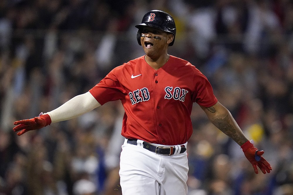 Rafael Devers of the Boston Red Sox is congratulated in the dugout