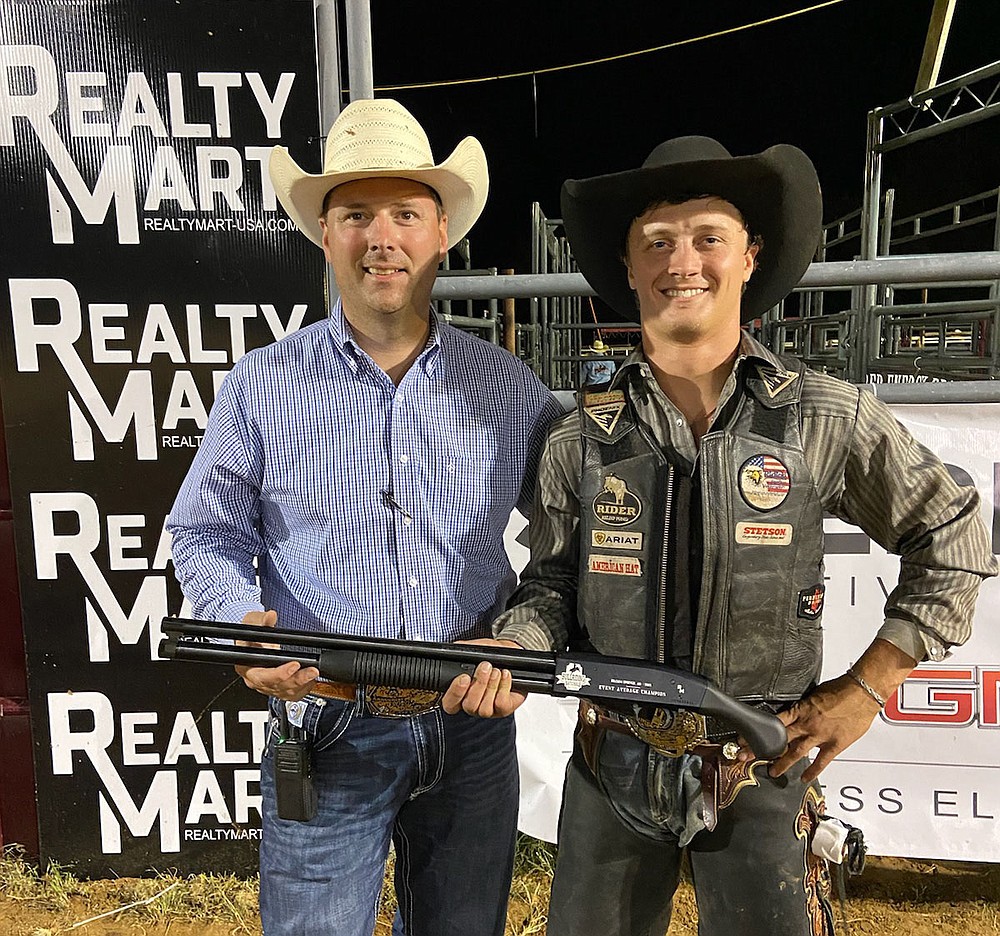 Photo Submitted Dakota Eagleburger (right), poses with Jeff Lee and his prize: an O.F. Mossberger and Sons rifle donated by Realty Mart USA. Eagleburger won the rifle during Event Average Championship
