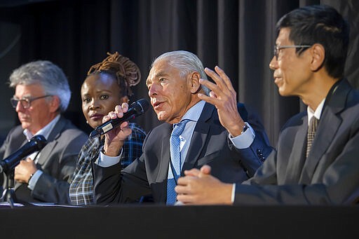 Patrick Aebischer, GESDA Vice Chairman, Nanjira Sambuli, Policy Analyst and Advocacy Strategist, Kenya, Peter Brabeck-Letmathe, GESDA Chairman, Chorh Chuan Tan, Chief Health Scientist, Singapore, left and right, speaks about the first Geneva Science and Diplomacy Anticipation Summit 2021 (GESDA), during a press conference at the Campus Biotech in Geneva, Switzerland, Thursday, October 07, 2021. (Martial Trezzini/Keystone via AP)