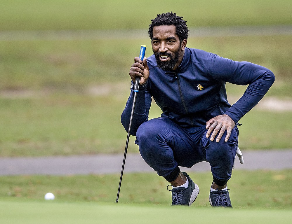 North Carolina A&T's J.R. Smith lines up his shot to the 17th green during the second round of the Phoenix Invitational golf tournament in Burlington, N.C., Tuesday, Oct. 12, 2021. Smith spent 16 years playing in the NBA, winning two world championships. (Woody Marshall/News & Record via AP)