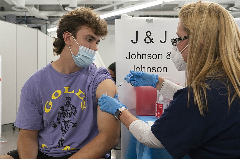 FILE - In this July 30, 2021, file photo, Bradley Sharp, of Saratoga, N.Y., gets the Johnson &amp; Johnson vaccine from registered nurse Stephanie Wagner in New York. Starting Thursday, Oct. 14, 2021, the Food and Drug Administration convenes its independent advisers for the first stage in the process of deciding whether extra shots of  Moderna or Johnson &amp; Johnson vaccines should be dispensed and, if so, who should get them and when. (AP Photo/Mark Lennihan, File)
