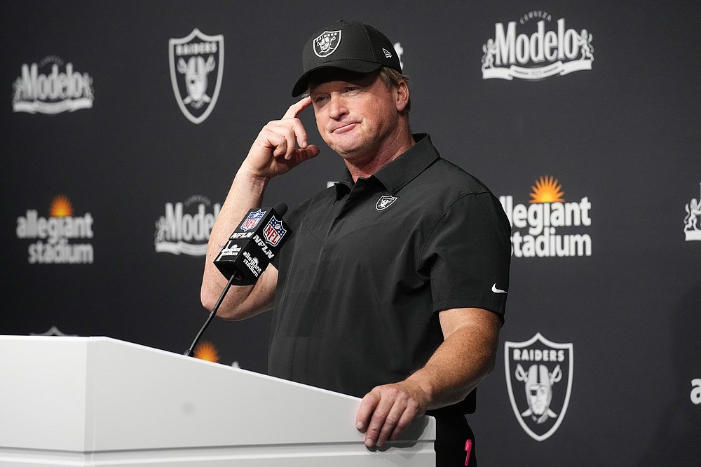 FILE - Las Vegas Raiders head coach Jon Gruden attends a news conference after an NFL football game against the Miami Dolphins in Las Vegas, in this Sunday, Sept. 26, 2021, file photo. Jon Gruden is out as coach of the Las Vegas Raiders after emails he sent before being hired in 2018 contained racist, homophobic and misogynistic comments. Gruden released a statement Monday night, Oct. 11, 2021, that he is stepping down after The New York Times reported that Gruden frequently used misogynistic and homophobic language directed at Commissioner Roger Goodell and others in the NFL.(AP Photo/Rick Scuteri, File)