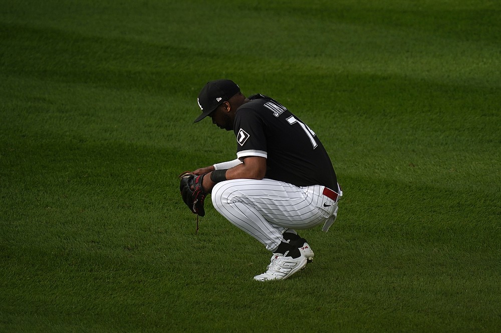 Chicago White Sox left fielder Eloy Jimenez waits during a mound visit against the Chicago White Sox in the eighth inning during Game 4 of a baseball American League Division Series Tuesday, Oct. 12, 2021, in Chicago. (AP Photo/Charles Rex Arbogast)