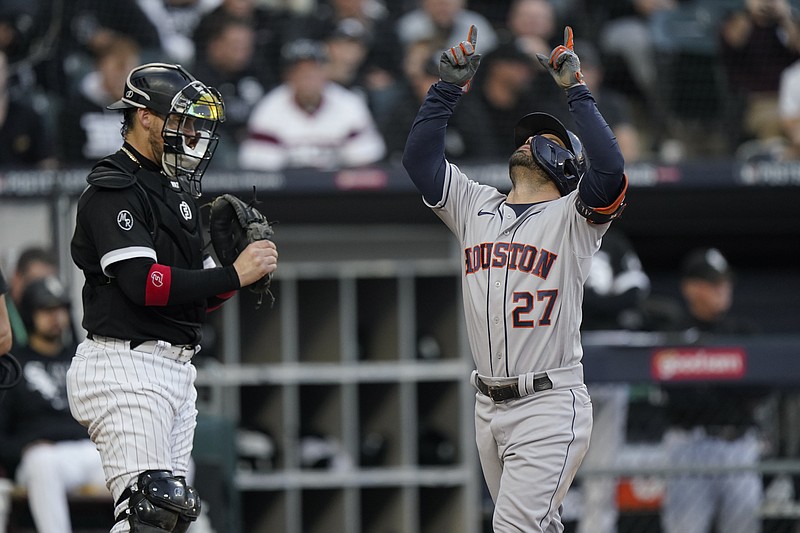 Houston Astros' Jose Altuve (27) celebrates his home run as Chicago White Sox catcher Yasmani Grandal looks on in the ninth inning during Game 4 of a baseball American League Division Series Tuesday, Oct. 12, 2021, in Chicago. (AP Photo/Nam Y. Huh)