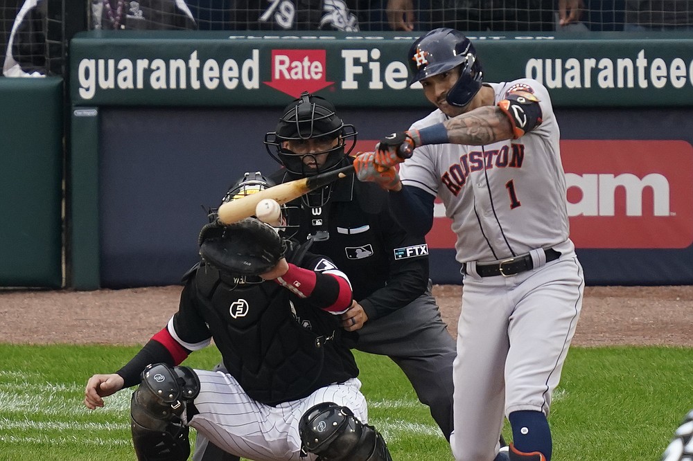 Houston Astros' Carlos Correa hits a two-run double against the Chicago White Sox in the third inning during Game 4 of a baseball American League Division Series Tuesday, Oct. 12, 2021, in Chicago. (AP Photo/Charles Rex Arbogast)