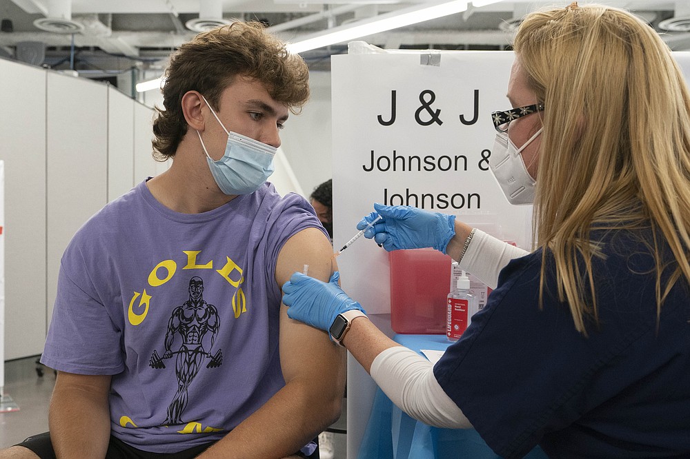 FILE - In this July 30, 2021, file photo, Bradley Sharp, of Saratoga, N.Y., gets the Johnson & Johnson vaccine from registered nurse Stephanie Wagner in New York. Starting Thursday, Oct. 14, 2021, the Food and Drug Administration convenes its independent advisers for the first stage in the process of deciding whether extra shots of Moderna or Johnson & Johnson vaccines should be dispensed and, if so, who should get them and when. (AP Photo/Mark Lennihan, File)