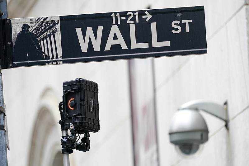 FILE - A Wall Street sign is seen next to surveillance equipment outside the New York Stock Exchange, Tuesday, Oct. 5, 2021, in New York.  Stocks are edging higher in early trading on Wall Street Tuesday, Oct. 12,  as traders wait for more data on inflation and corporate earnings this week.    (AP Photo/Mary Altaffer)