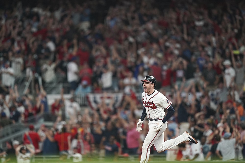 Atlanta Braves' Freddie Freeman (5) celebrates his solo homerun during the eighth inning of Game 4 of a baseball National League Division Series against the Milwaukee Brewers, Tuesday, Oct. 12, 2021, in Atlanta. (AP Photo/Brynn Anderson)