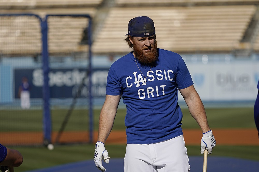 Los Angeles Dodgers third baseman Justin Turner holds a bat during batting practice before Game 4 of the baseball team's National League Division Series against the San Francisco Giants, Tuesday, Oct. 12, 2021, in Los Angeles. (AP Photo/Marcio Jose Sanchez)