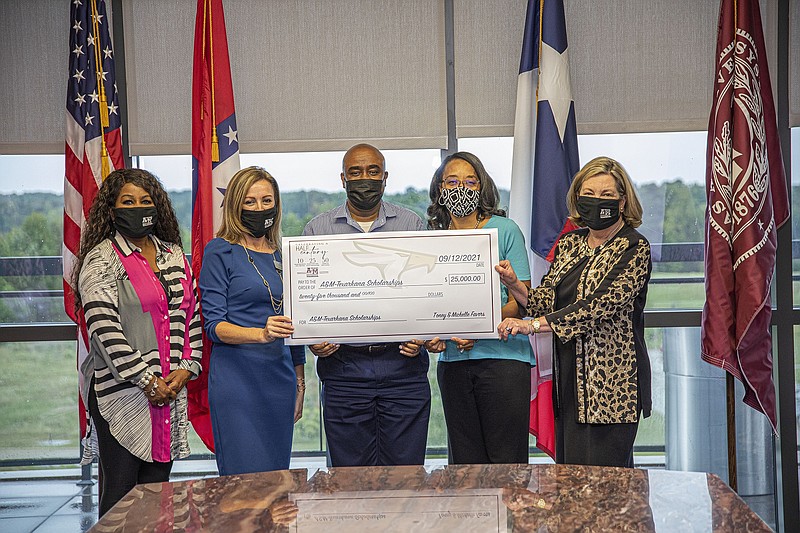Pictured from left: Lekia Jones and Nicole Raley (representing the Anniversary Celebration Fundraising Committee), Toney Favors, Michelle Favors and A&M-Texarkana President Dr. Emily Cutrer. (Photo courtesy of John Bunch/TAMU-T)