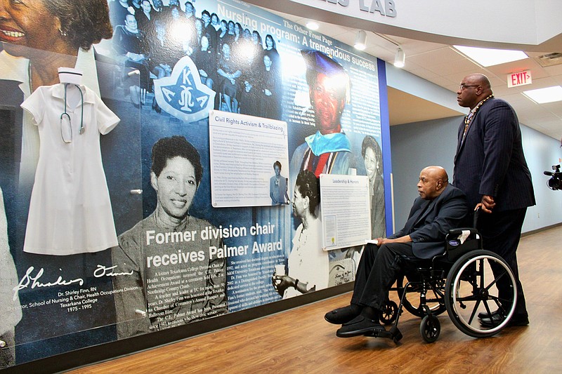 Edwin and Michael Finn, left and right, observe the Dr. Shirley Finn, RN, mural at Texarkana College. (Photo courtesy of Suzy Irwin/TC)