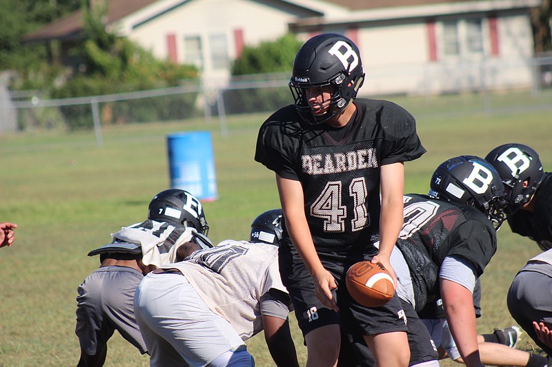 Photo By: Michael Hanich
Bearden quarterback Kathan Emerson gets ready to make a hand-off in practice