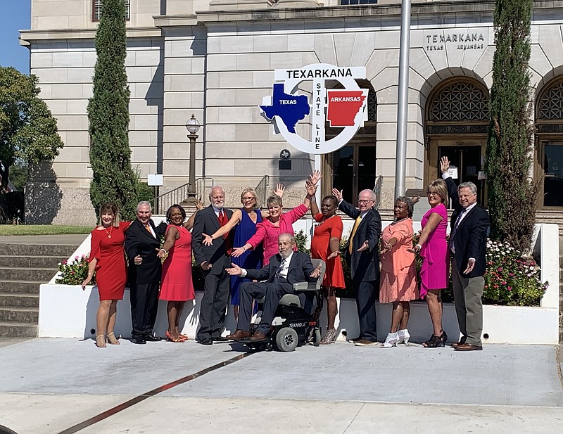 photo by Lori Dunn
The ArkLaTex 60 Strong calendar models pose for a group photo in front of the downtown Texarkana Federal Building.