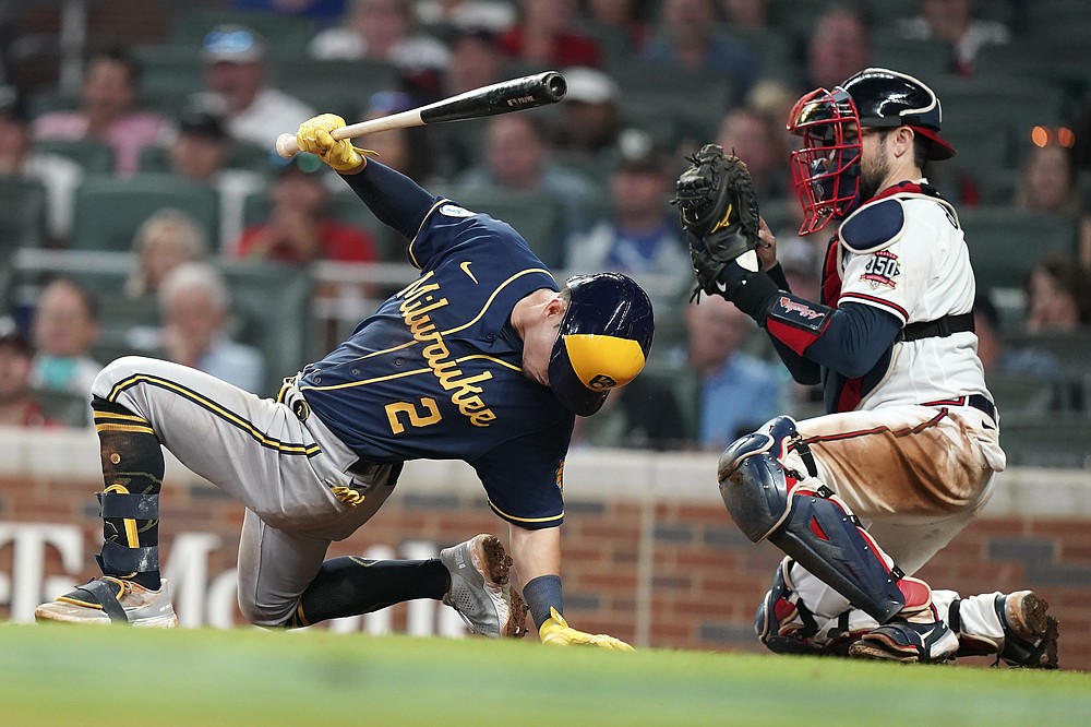 Milwaukee Brewers' Luis Urias (2) avoids a ball at the plate pitched by Atlanta Braves relief pitcher Tyler Matzek (68) during the eighth inning of Game 4 of a baseball National League Division Series, Tuesday, Oct. 12, 2021, in Atlanta. (AP Photo/Brynn Anderson)