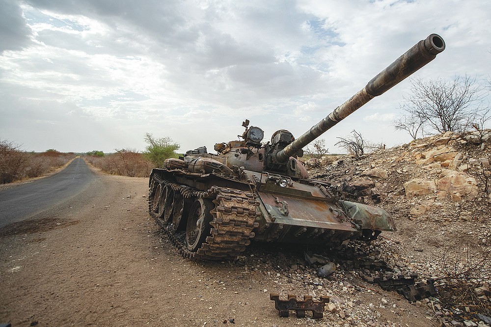 FILE - In this Saturday, May 1, 2021 file photo, a destroyed tank is seen by the side of the road south of Humera, in an area of western Tigray then annexed by the Amhara region during the ongoing conflict, in Ethiopia. Tigray forces say Ethiopia&#x2019;s government has launched its threatened major military offensive against them in an attempt to end a nearly year-old war. A statement from the Tigray external affairs office on Monday, Oct. 11 alleged that hundreds of thousands of Ethiopian &#x201c;regular and irregular fighters&#x201d; launched a coordinated assault on several fronts. (AP Photo/Ben Curtis, File)
