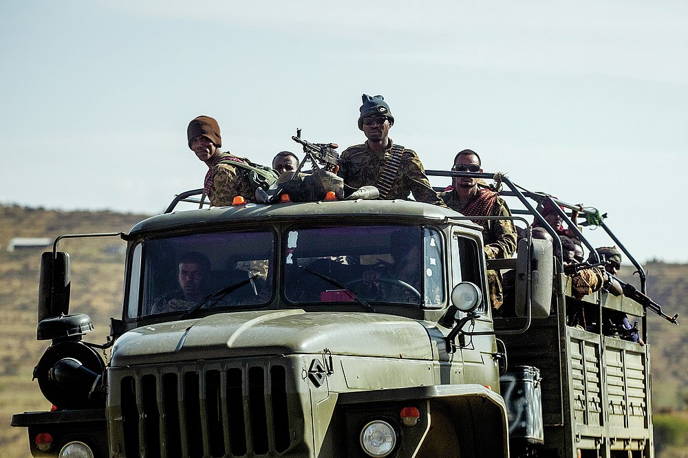 FILE - In this Saturday, May 8, 2021 file photo, Ethiopian government soldiers ride in the back of a truck on a road near Agula, north of Mekele, in the Tigray region of northern Ethiopia. Tigray forces say Ethiopia&#x2019;s government has launched its threatened major military offensive against them in an attempt to end a nearly year-old war. A statement from the Tigray external affairs office on Monday, Oct. 11 alleged that hundreds of thousands of Ethiopian &#x201c;regular and irregular fighters&#x201d; launched a coordinated assault on several fronts. (AP Photo/Ben Curtis, File)