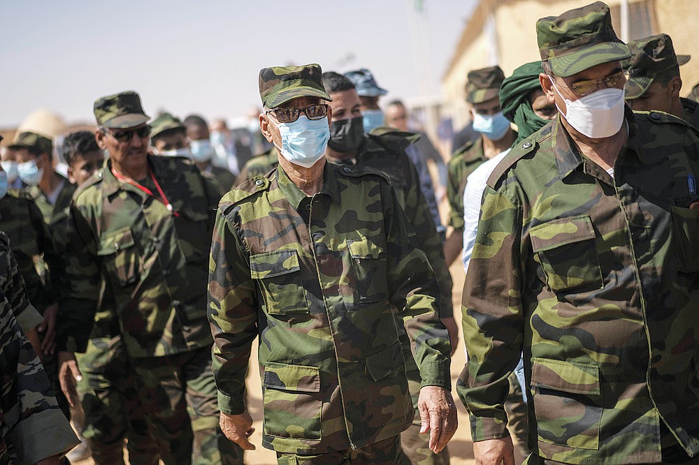 Brahim Ghali, head of the Polisario Front and the self-declared Sahrawi Democratic Arab Republic, center, attends a National Unity Day event in the Dajla refugee camp, Algiers, Tuesday, Oct. 12, 2021. (AP Photo/Bernat Armangue)