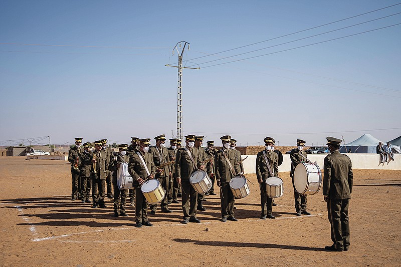 A Polisario Front military orchestra perform during a National Unity Day event in the Dajla refugee camp, Algeria, Tuesday, Oct. 12, 2021. (AP Photo/Bernat Armangue)