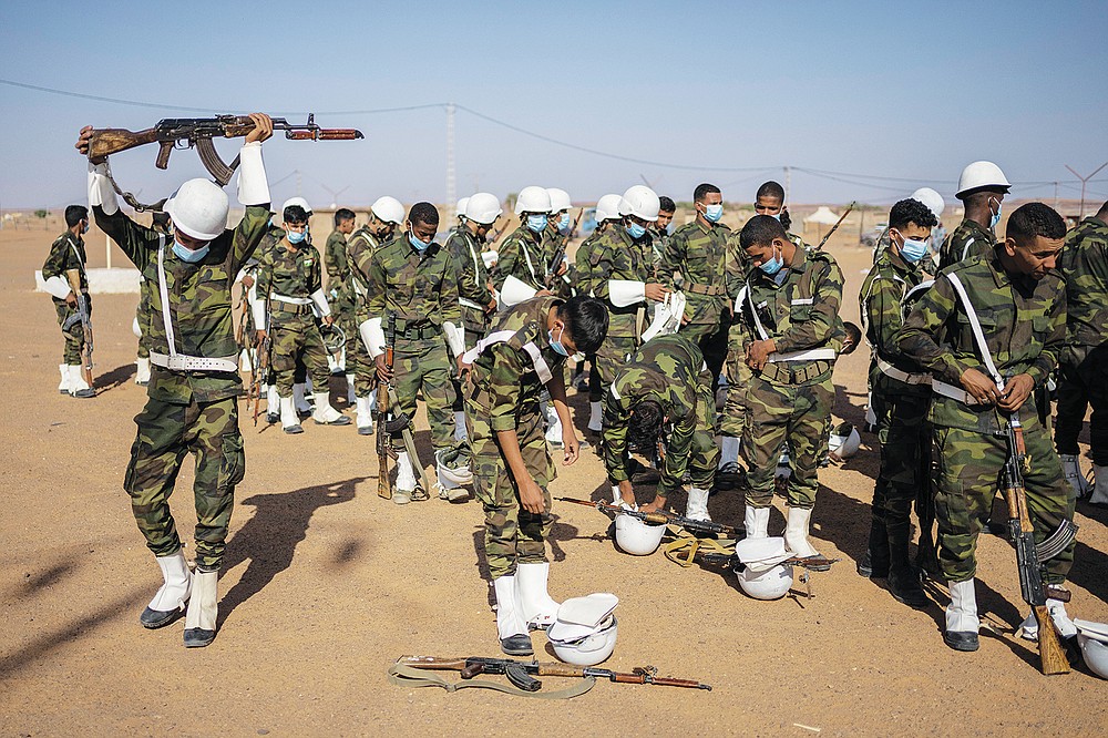 Soldiers from the Polisario Front pack after a National Unity Day event in the Dajla refugee camp, Algeria, Tuesday, Oct. 12, 2021. (AP Photo/Bernat Armangue)