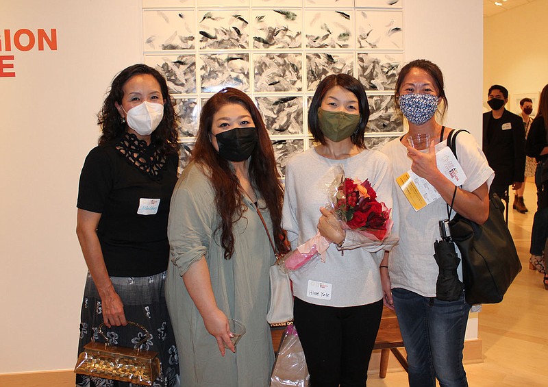 Artist Hisae Yale (second from right) is joined by Ai Nakanishi (from right), Mari Rieck and Miho Sakon at the opening reception for &quot;Our Art, Our Region, Our TIme&quot; on Sept. 30 at the Walton Arts Center in Fayetteville. Behind them is &quot;Moving Forward II,&quot; Yale's submission to the exhibition.
(NWA Democrat-Gazette/Carin Schoppmeyer)