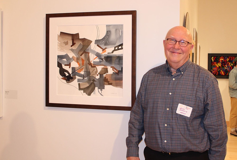Artist Gary Johnson displays his work, "Danger at the Crossroads" at the Our ART opening reception.
(NWA Democrat-Gazette/Carin Schoppmeyer)