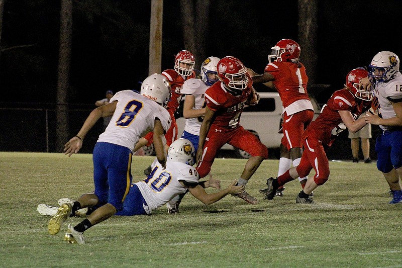 Mountain Pine's Keelan Dobbins (4) breaks through on a run during last Friday's game against Spring Hill at Stanley May Field. The Red Devils travel to Strong Friday to take on the Bulldogs. - Photo by James Leigh of The Sentinel-Record