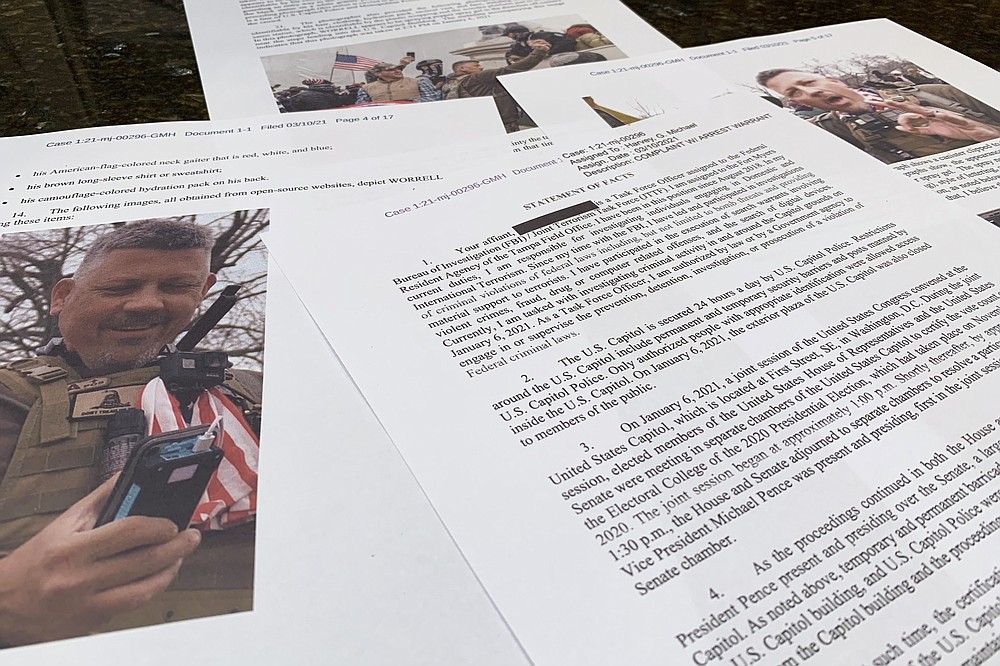 This photo shows part of the Justice Department's statement of facts in the complaint and arrest warrant for Christopher Worrell. In a case involving the Jan. 6 Capitol riot defendant, U.S. District Judge Royce Lamberth held the District of Columbia's corrections director and jail warden in contempt of court on Oct. 13, and asked the Justice Department to investigate whether inmates' civil rights are being abused. Lamberth had summoned the jail officials as part of the criminal case into Worrell, a member of the Proud Boys who has been charged in the Jan. 6 attack. Capitol. He has been accused of attacking police officers with a pepper spray gel and prosecutors have alleged he traveled to Washington and coordinated with Proud Boys leading up to the siege. (AP Photo/Jon Elswick)