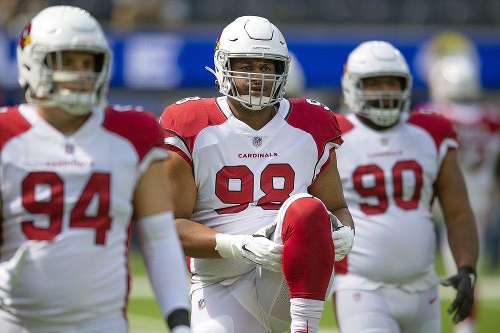 FILE - In this Sunday, Oct. 3, 2021, file photo, Arizona Cardinals defensive tackle Corey Peters (98) stretches before an NFL football game against the Los Angeles Rams in Los Angeles. Current or former players, along with people in positions of leadership with NFL clubs, have offered differing opinions this week on how pervasive the sorts of racist, homophobic and misogynistic thoughts expressed by Jon Gruden -- in emails he wrote from 2011-18, when he was an ESPN analyst between coaching jobs, to then-Washington club executive Bruce Allen – remain around the sport to this day. (AP Photo/John McCoy, File)