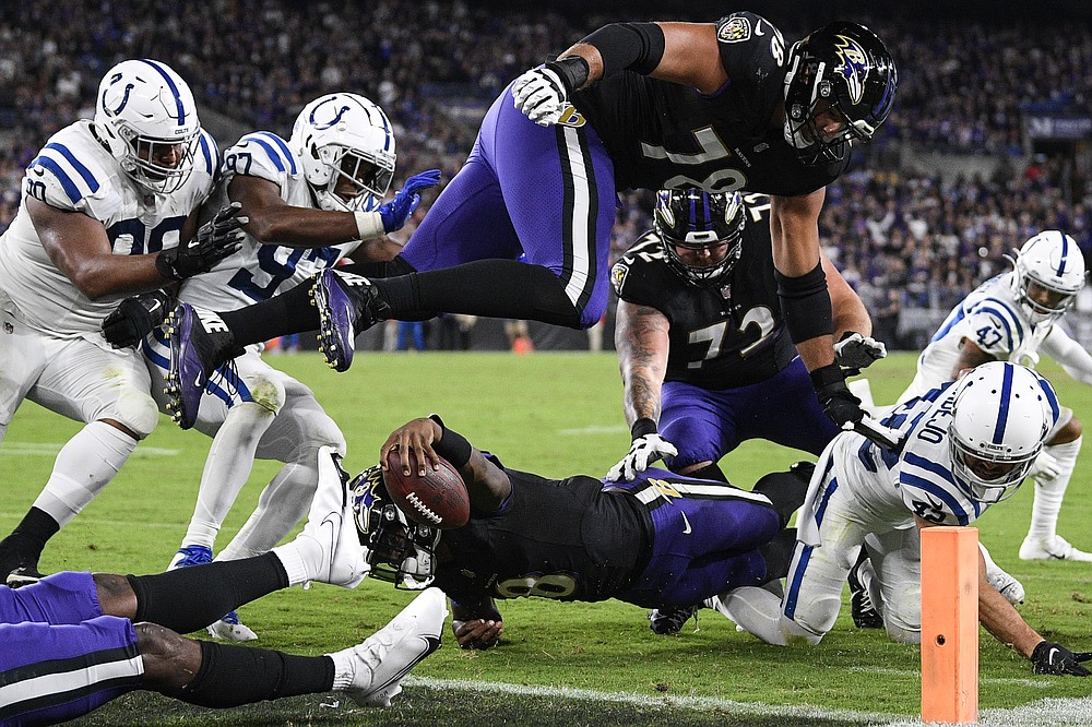 Baltimore Ravens quarterback Lamar Jackson (8) stretches for a failed attempt for a 2-point conversion during the second half of an NFL football game against the Indianapolis Colts, Monday, Oct. 11, 2021, in Baltimore. (AP Photo/Nick Wass)