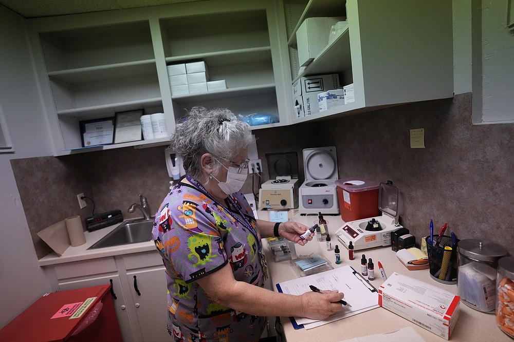 Lab technician Stephannie Chaffee prepares materials that will be used to test women's blood ahead of the arrival of patients, Saturday, Oct. 9, 2021, at Hope Medical Group for Women in Shreveport, La. The nation's most restrictive abortion law is driving many women from Texas to seek services in neighboring states. The abortion clinic in Shreveport is among the clinics being inundated. (AP Photo/Rebecca Blackwell)